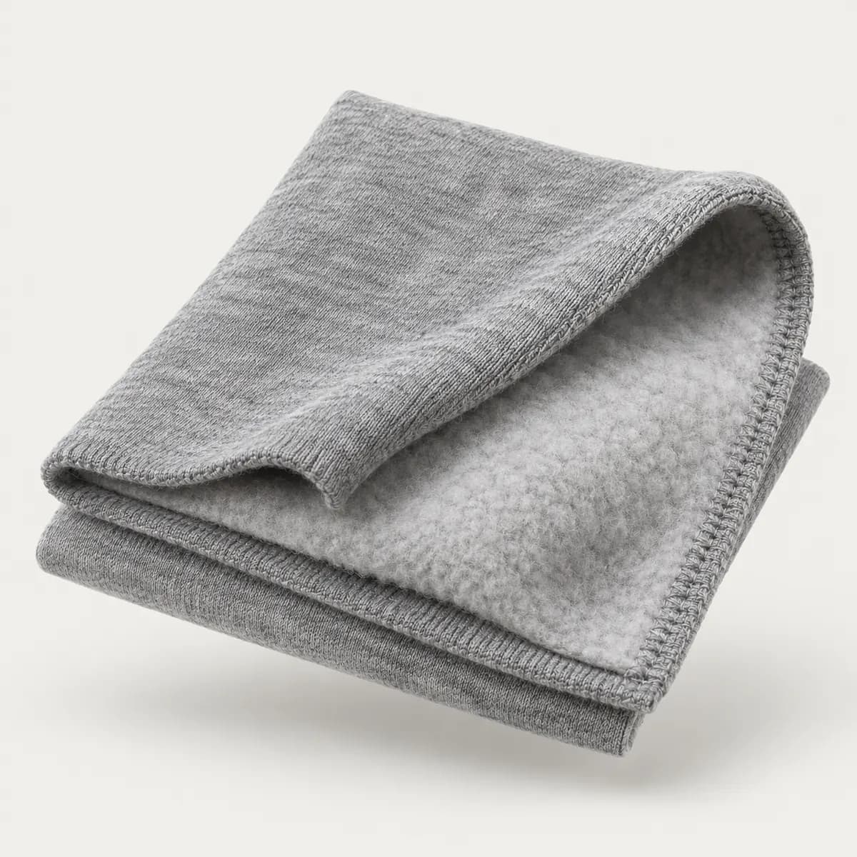 Folded heather grey cotton fleece swatch showing the brushed inner side