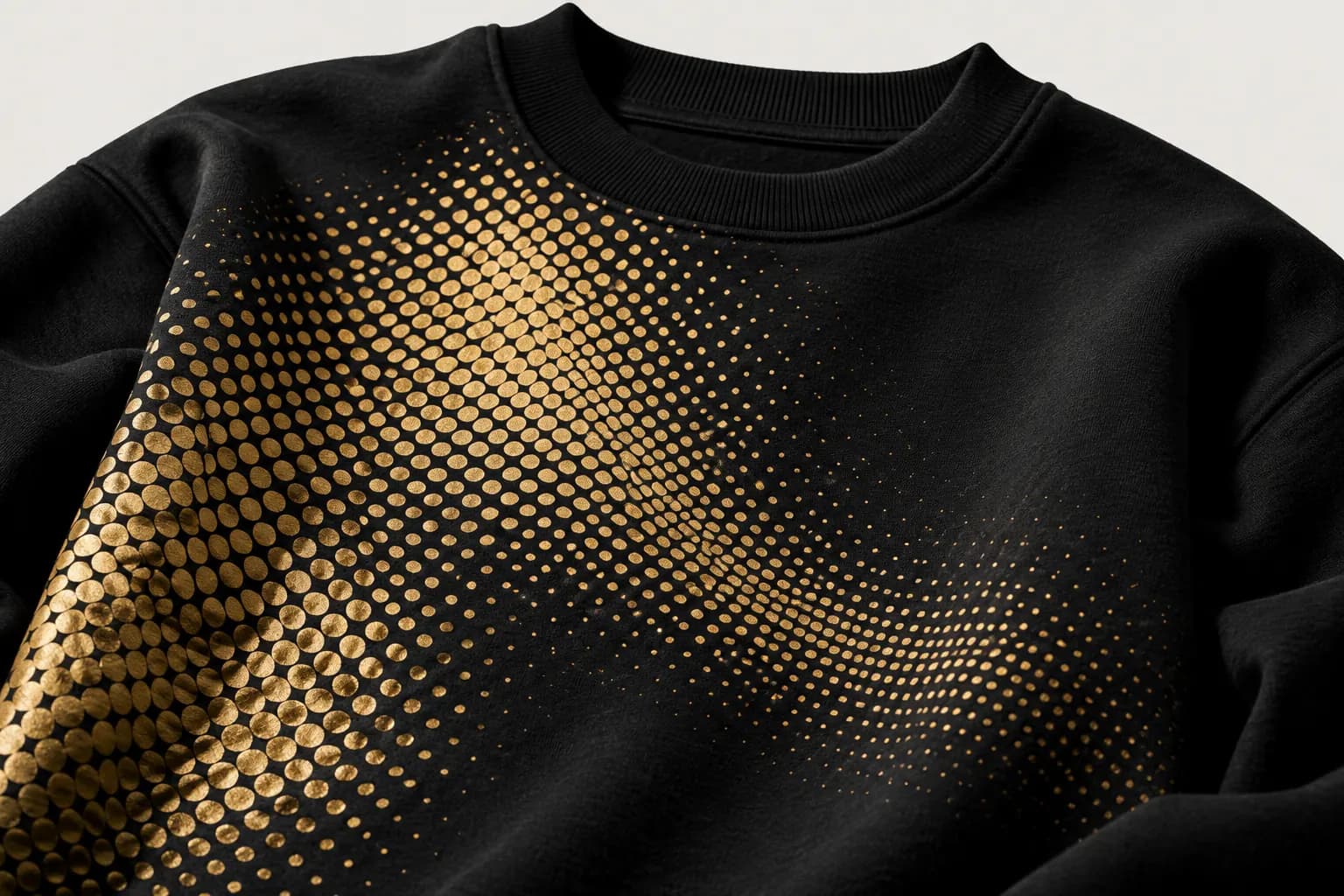 Gold halftone dot gradient printed on a black sweatshirt
